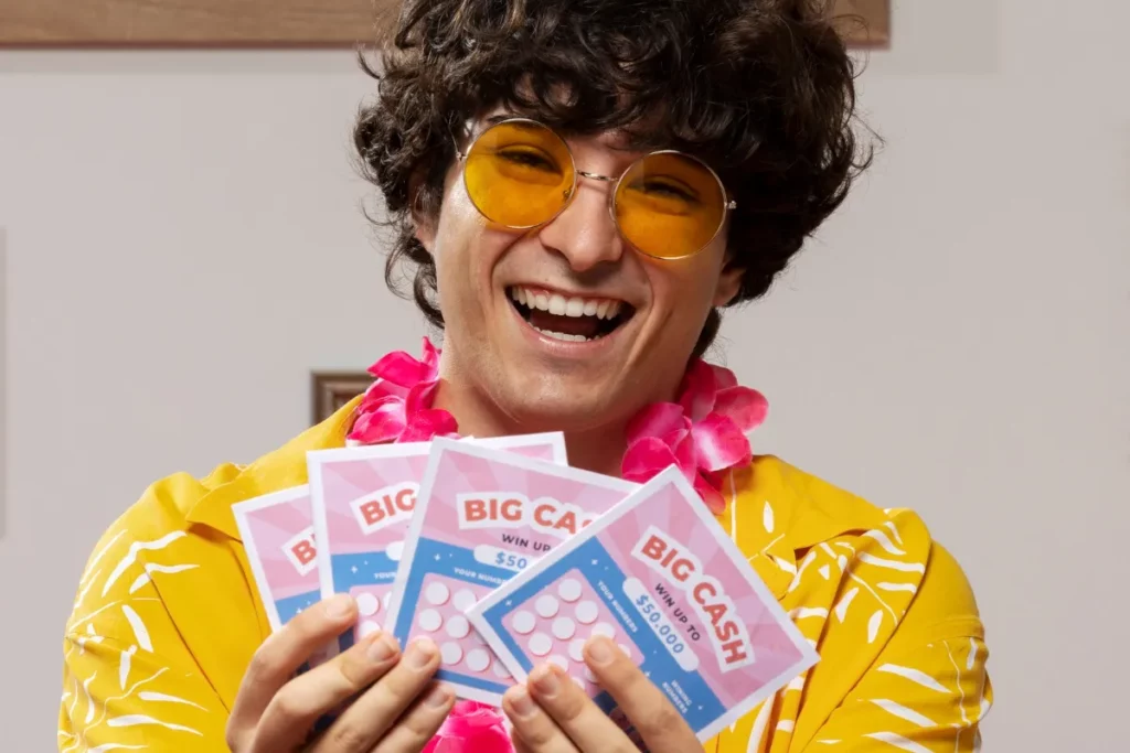 Homem segurando cartela de bingo, sorrindo e usando óculos escuro